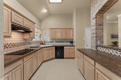 a bedroom with a large bed a couch and dresser