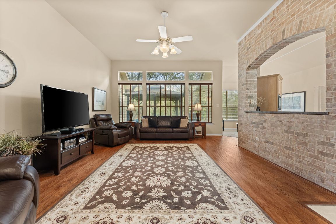 603 Flamingo Boulevard Lakeway, TX 78734 - Photo 4 of 40 The family room looks out over the backyard and has a brick accent wall