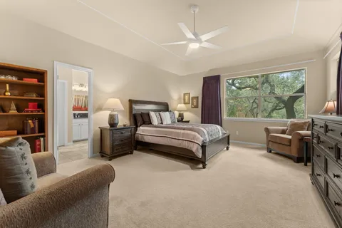a bedroom with furniture and a large window