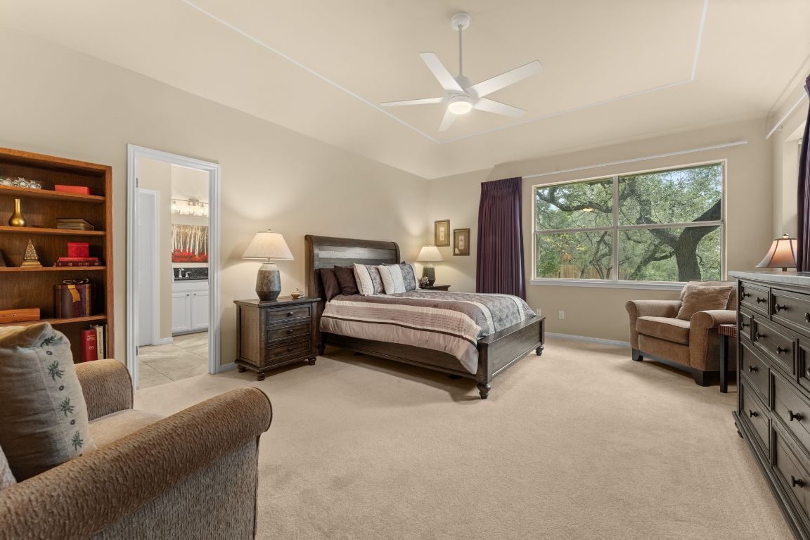 603 Flamingo Boulevard Lakeway, TX 78734 - Photo 7 of 40 The primary bedroom is DALLAS size with large windows looking into the parklike backyard.
