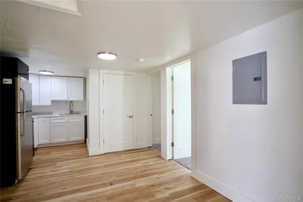 a view of a kitchen with a sink and a refrigerator