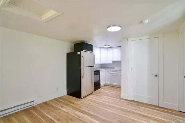 a view of a kitchen with a sink and a refrigerator