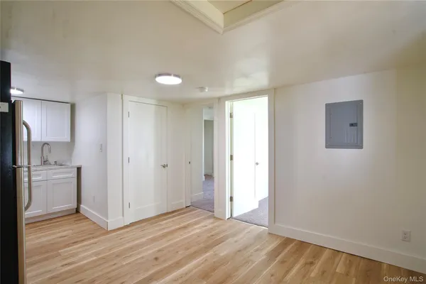 a view of a kitchen with a sink and a refrigerator