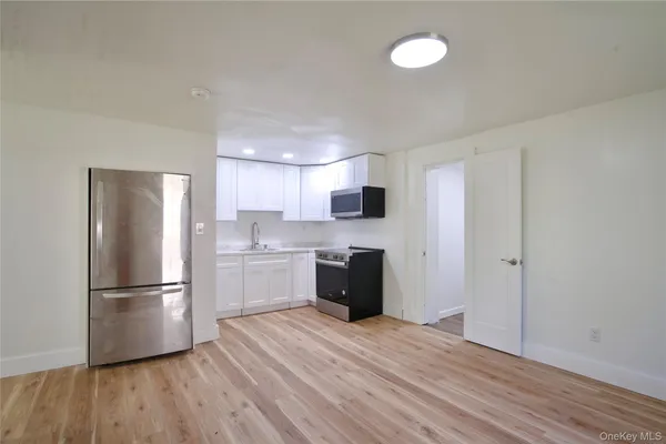 a kitchen with a refrigerator and a stove top oven