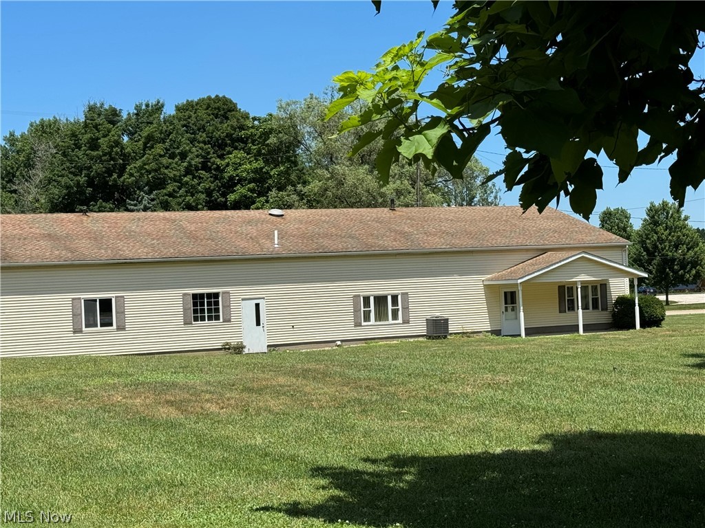 6900 North Ridge Road East Geneva, OH 44041 - Photo 37 of 37 Rear view of property with a yard and central AC unit