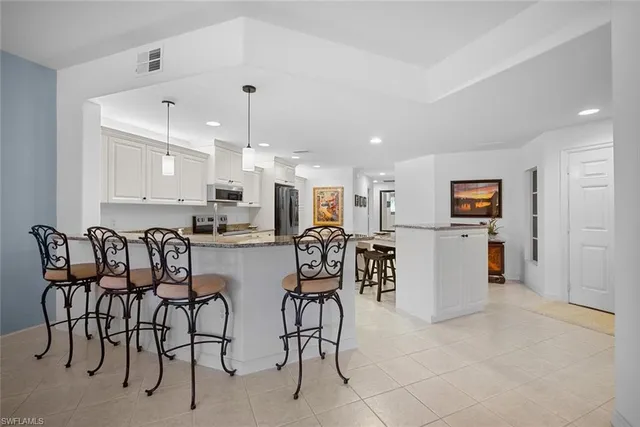 a kitchen with stainless steel appliances granite countertop a sink and a stove