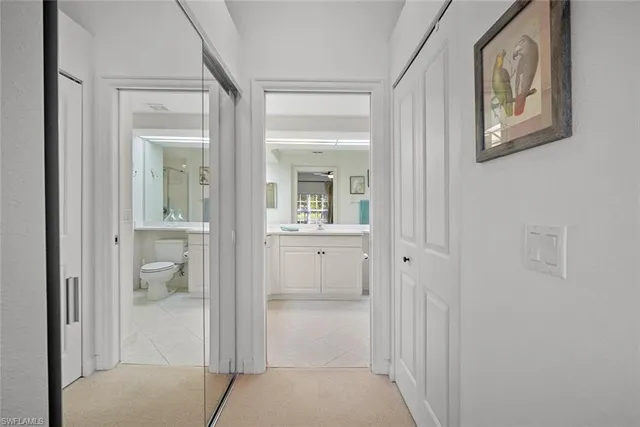 a bathroom with a granite countertop sink toilet a large mirror a shower and