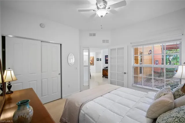 a bedroom with two beds and painting on the wall