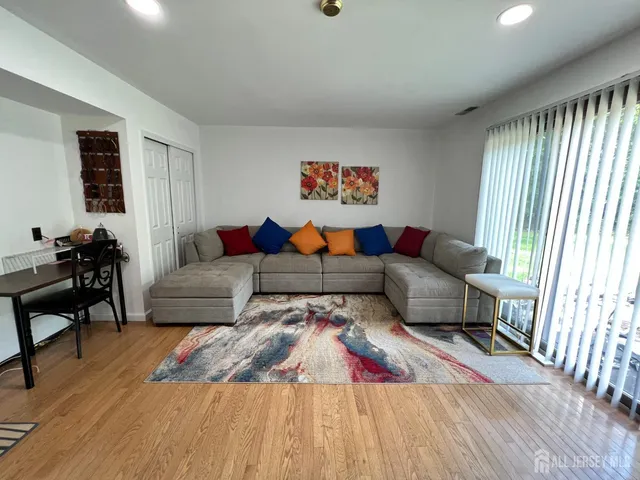 a living room with furniture and a large window