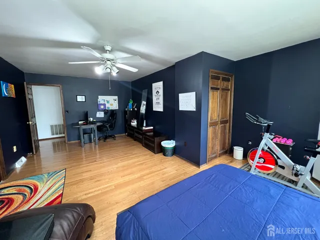 a living room with furniture and a flat screen tv with kitchen view