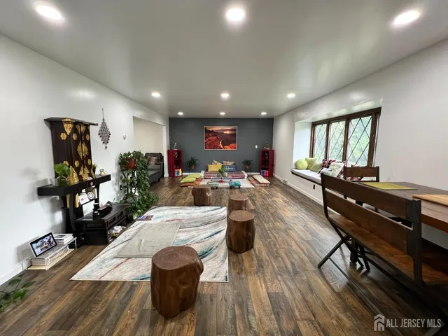a living room with furniture a wooden floor and a window
