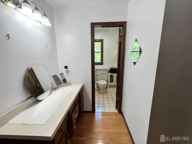 a room that has a bed and a mirror in it