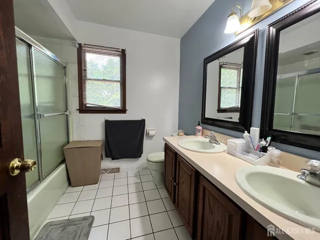 a bathroom with a sink a toilet and mirror