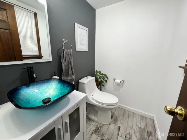a bathroom with a sink toilet and mirror