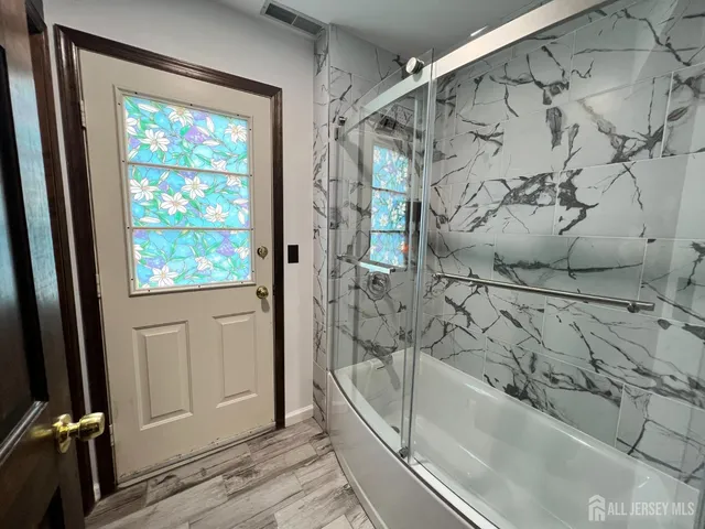 a bathroom with a bathtub and shower
