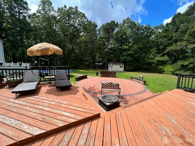 a view of a backyard with sitting area