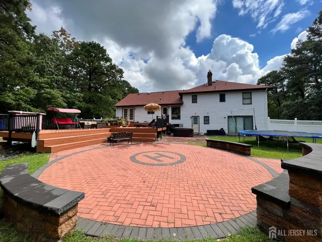 a swimming pool with outdoor seating and yard
