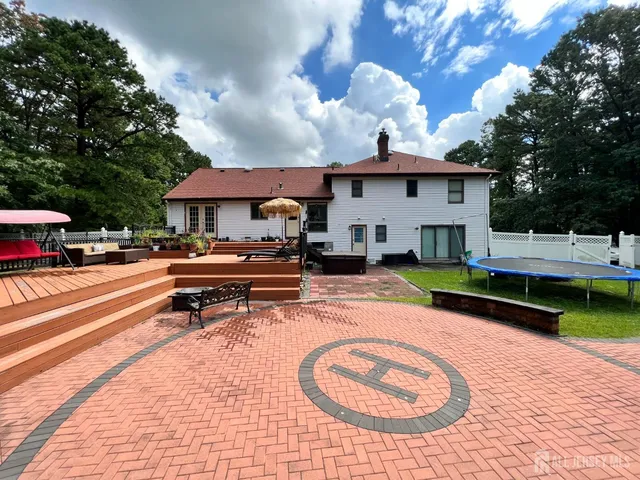 a view of a house with swimming pool and sitting area