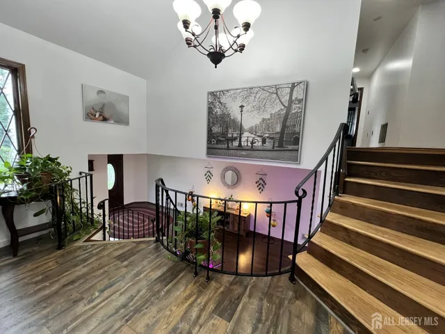 a view of entryway dining room and hall with wooden floor