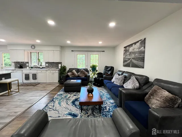 a living room with furniture and a wooden floor