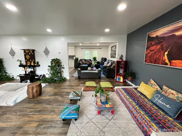 a living room with furniture and wooden floor