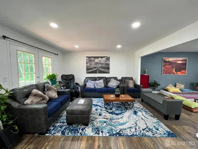 a living room with furniture rug and window