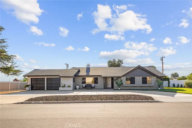a aerial view of a house with a big yard and large trees