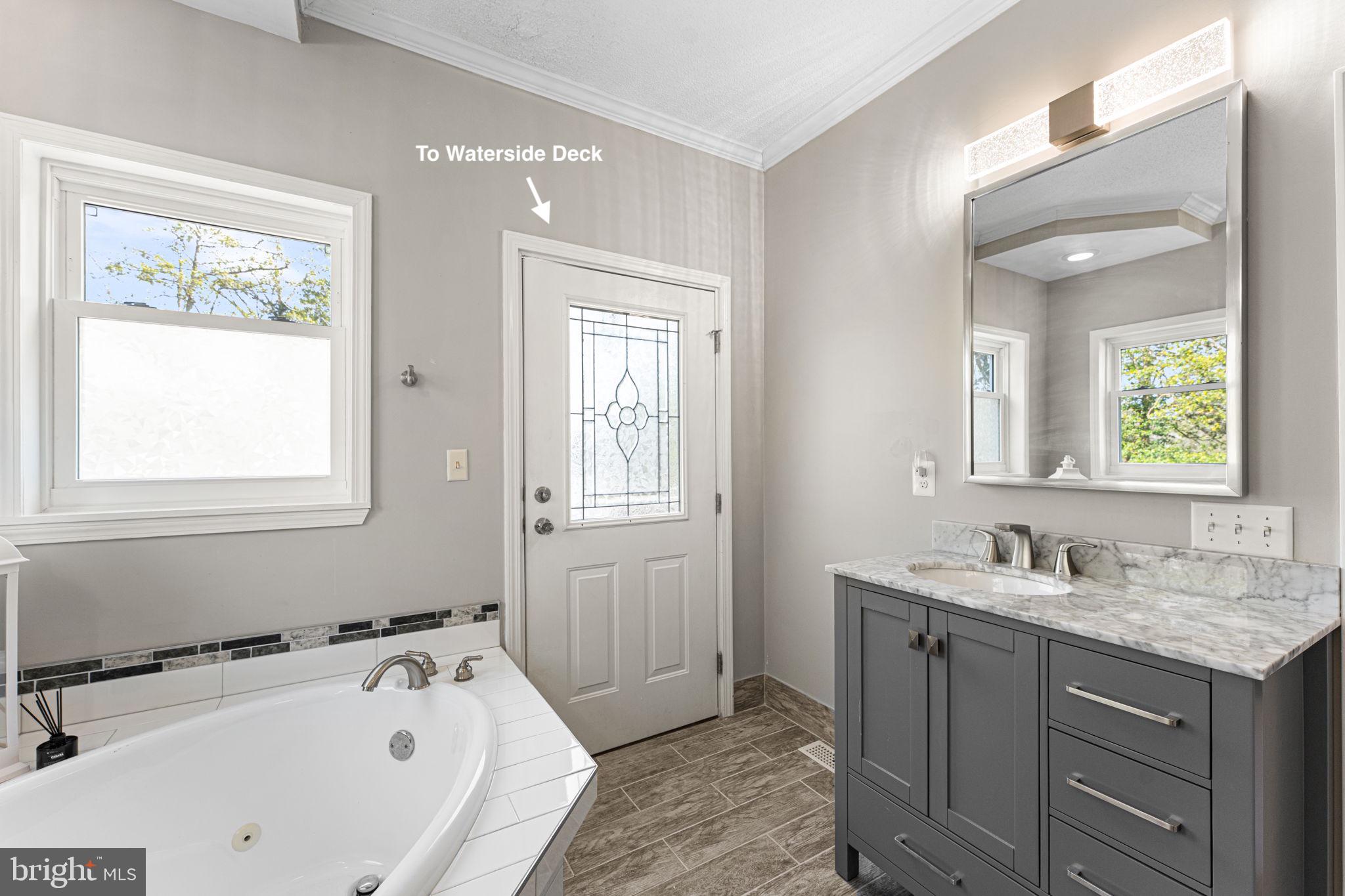 249 Spring Hill Road Lancaster, VA 22503 - Photo 22 of 65 a bathroom with a tub sink and mirror