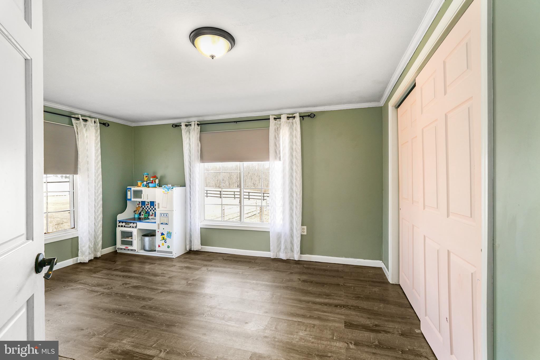 3050 Singerly Road Elkton, MD 21921 - Photo 13 of 24 an empty room with wooden floor and windows