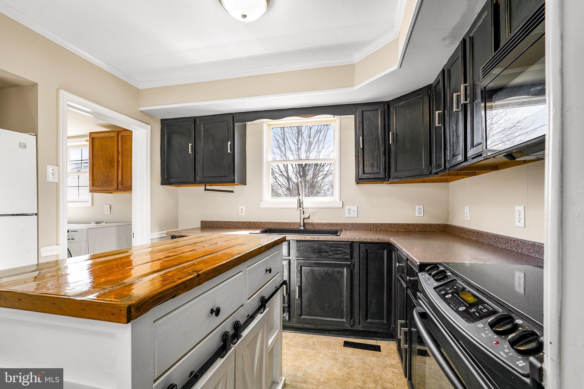 3050 Singerly Road Elkton, MD 21921 - Photo 5 of 24 a kitchen with a sink stove top oven and cabinets