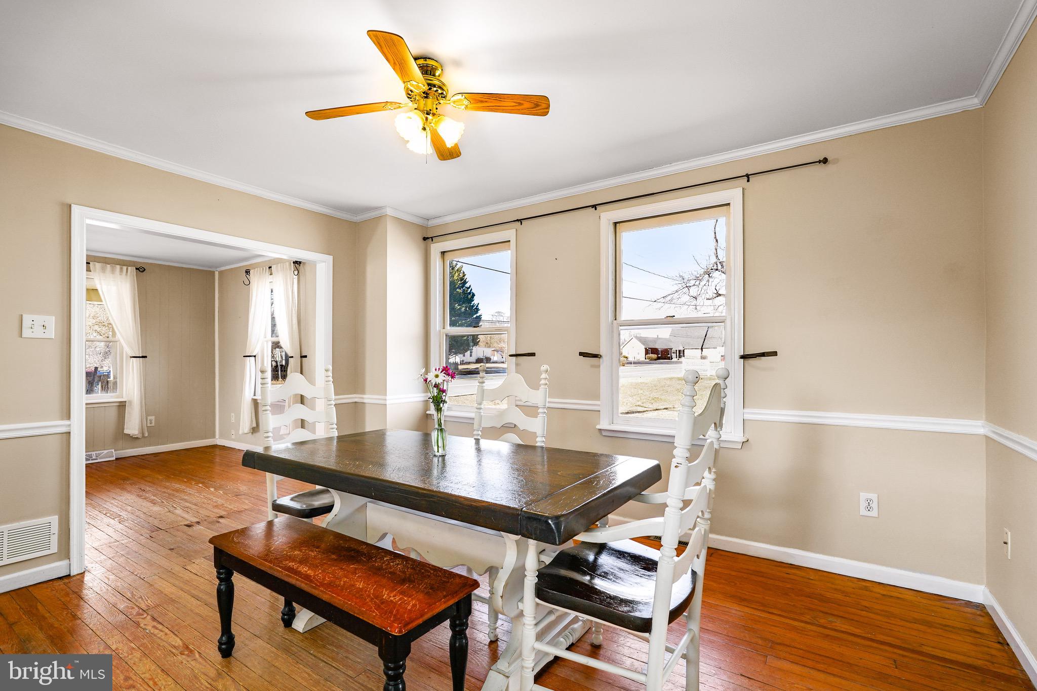 3050 Singerly Road Elkton, MD 21921 - Photo 9 of 24 a dining hall with a dining table and chairs with wooden floor