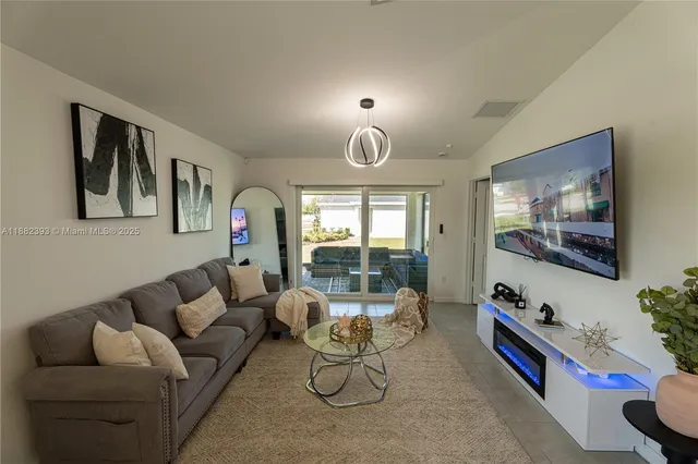 a living room with furniture and a potted plant