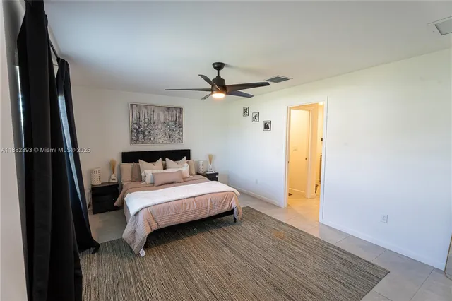 a bedroom with a large bed and a window