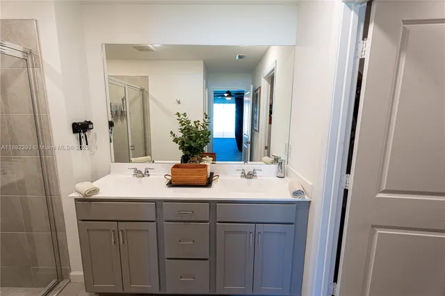 a bathroom with a shower and a sink