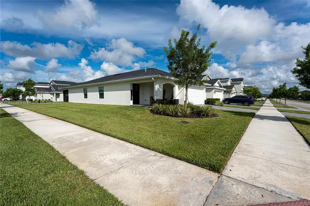 a front view of a house with a garden