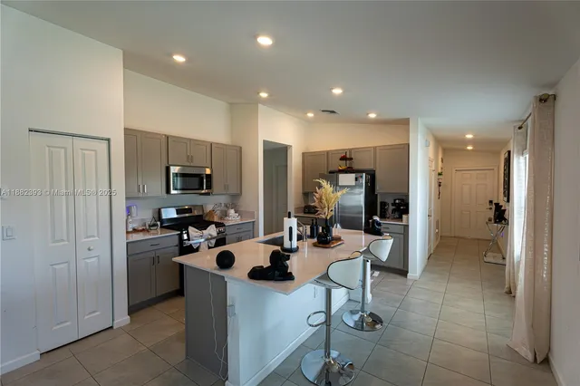 a kitchen with stainless steel appliances granite countertop a sink dishwasher stove and refrigerator