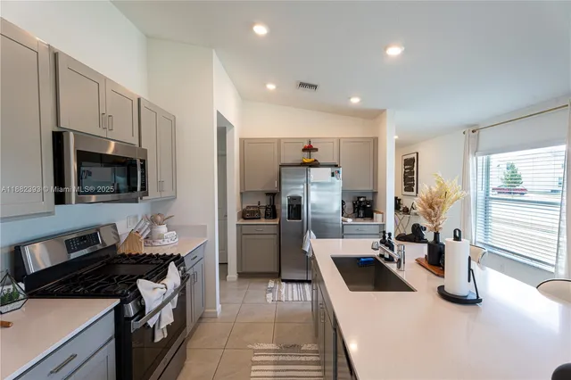 a kitchen with refrigerator a sink and cabinets