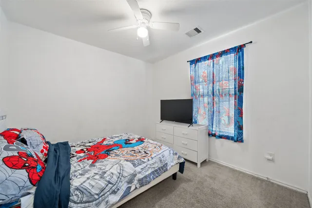 a bedroom with a bed and a tv