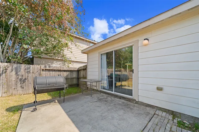 a view of a backyard with a small cabin and wooden fence