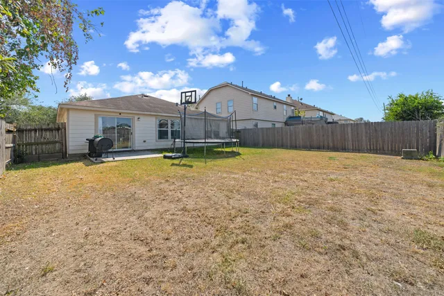 a front view of house with yard and swimming pool