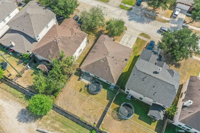an aerial view of a house with a yard