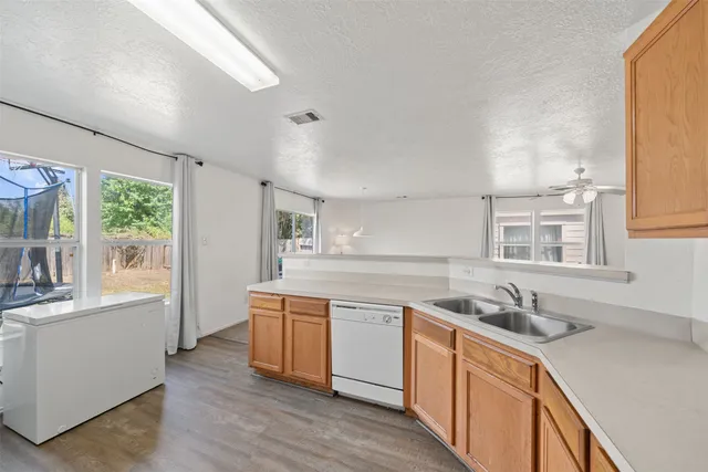a kitchen with stainless steel appliances granite countertop a sink stove and cabinets