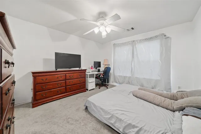 a bed room with a bed and a television