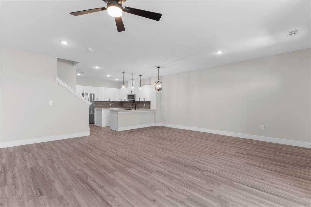 1650 Palladio Loop, Unit 2 Princeton, TX 75407 - Photo 8 of 14 Open-concept living space featuring wood-finish flooring, recessed lighting, and a contemporary ceiling fan