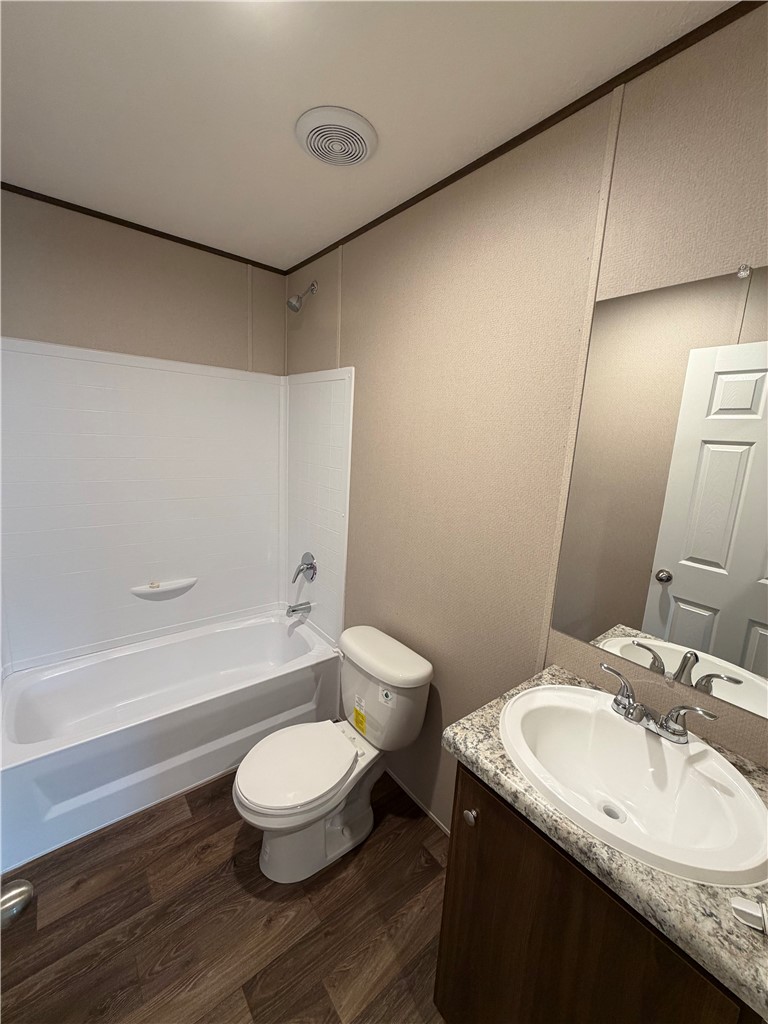 1411 Slaton Road Townville, SC 29689 - Photo 17 of 17 Functional bathroom design incorporates a practical tub shower combination and rich wood-look flooring.