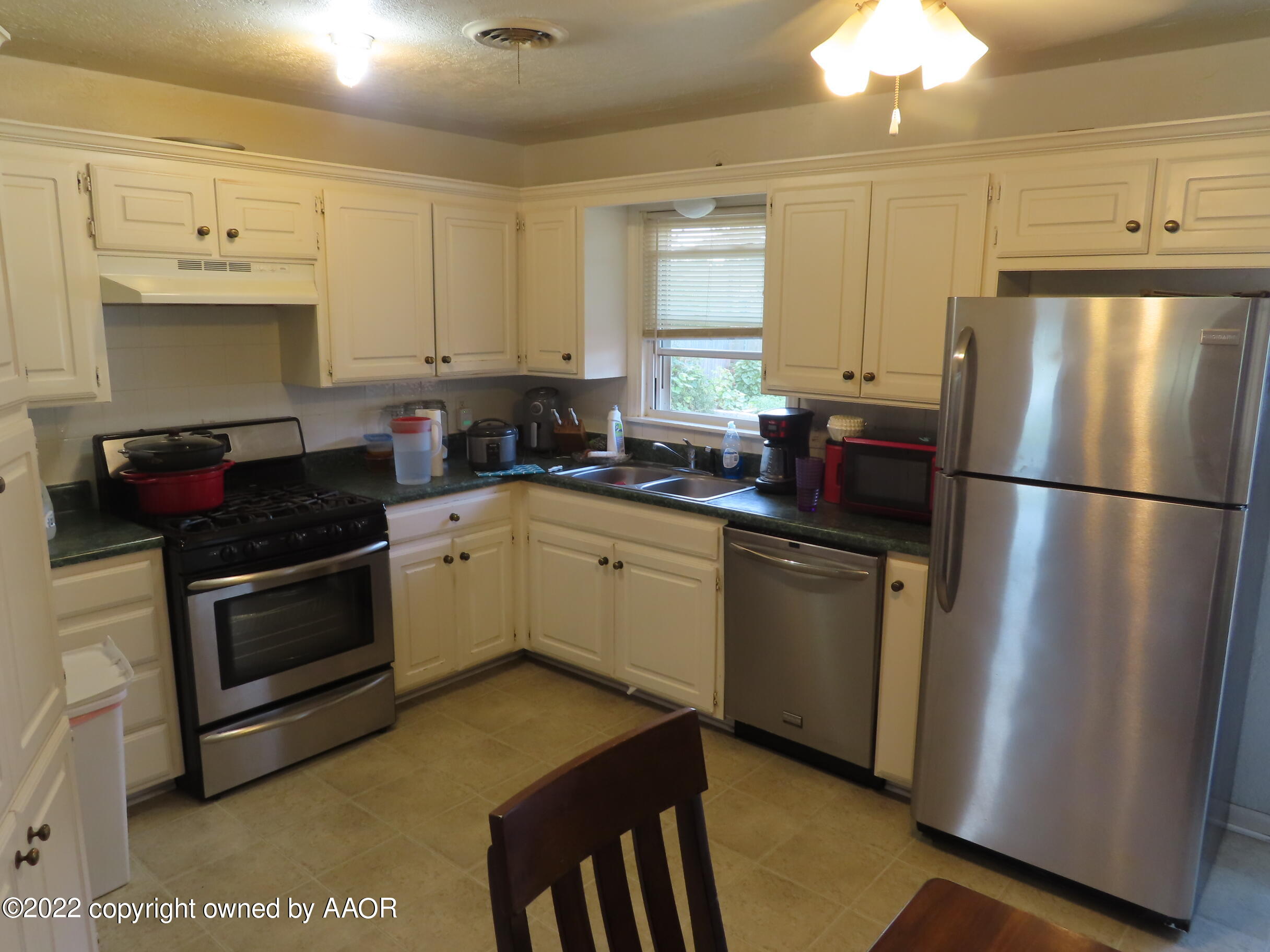4602 South Rusk Street Amarillo, TX 79110 - Photo 3 of 16 a kitchen with a sink appliances and cabinets