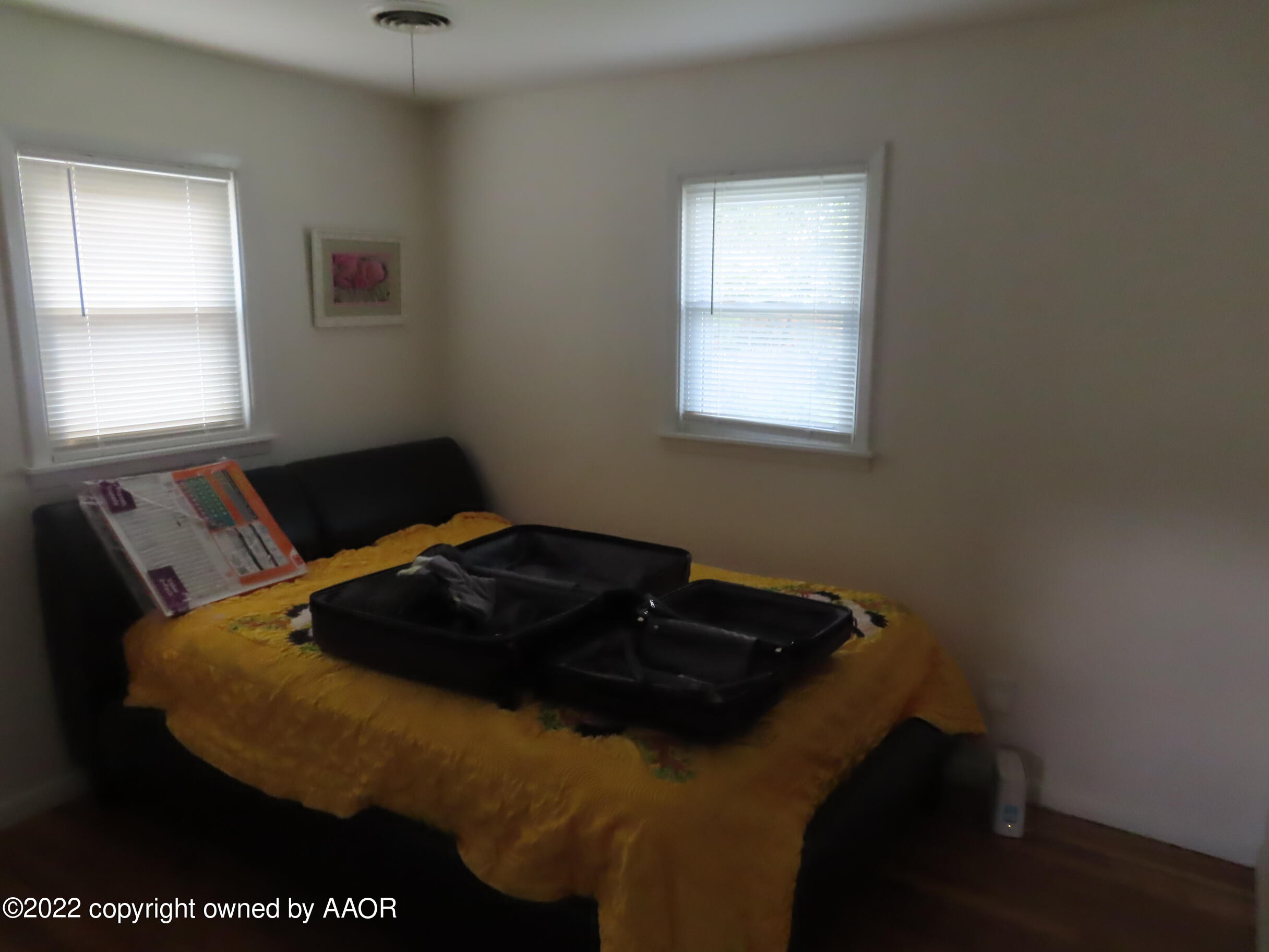 4602 South Rusk Street Amarillo, TX 79110 - Photo 10 of 16 a bedroom with a bed window and mirror