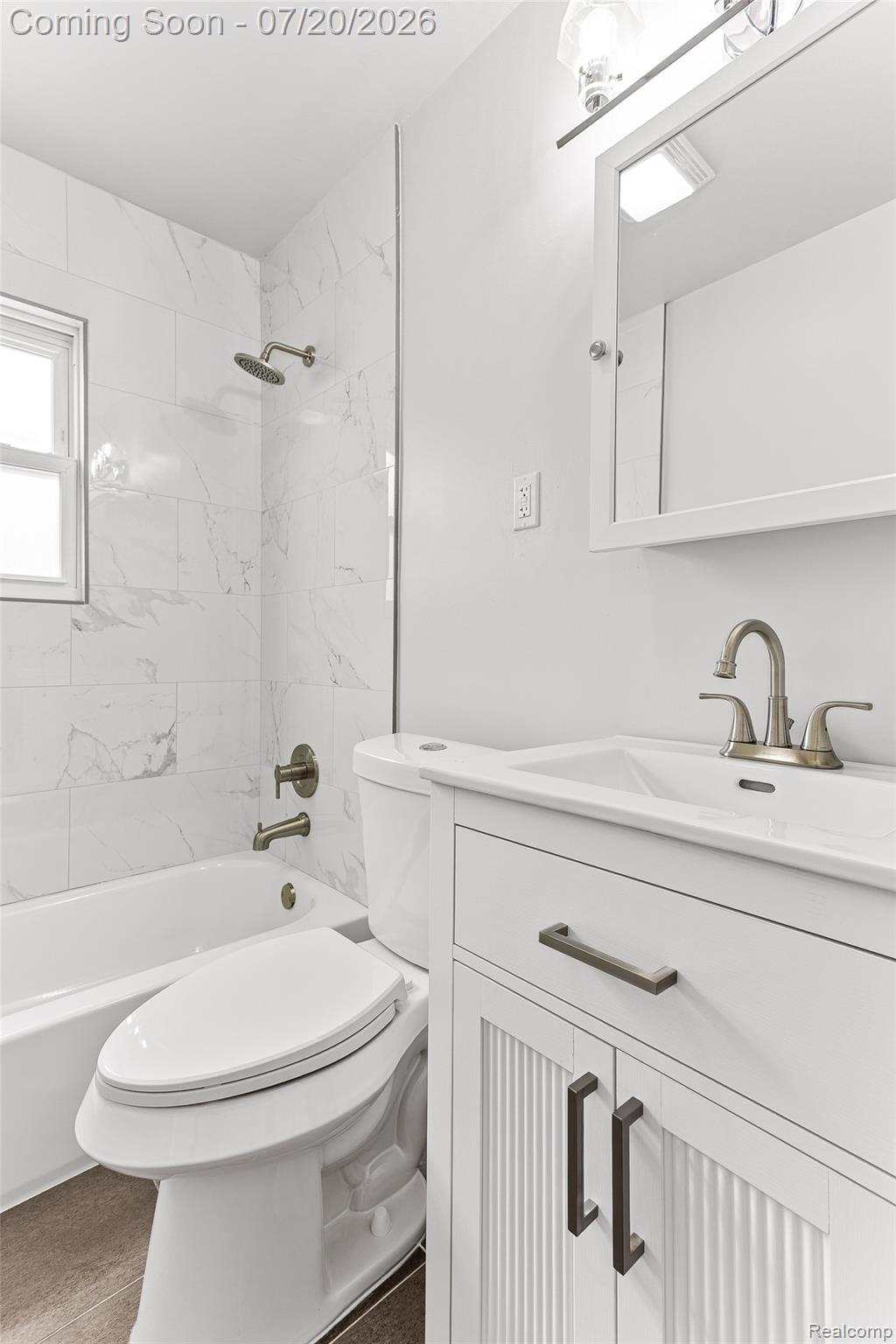 7884 Pardee Road Taylor, MI 48180 - Photo 15 of 23 Full bathroom featuring a white vanity with dark hardware, white subway tile shower surround, and a rain shower head
