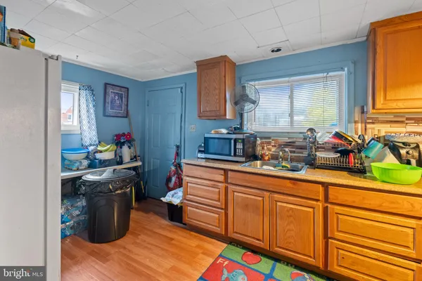a kitchen with a sink stove and wooden cabinets