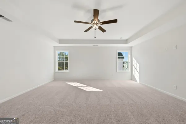 a view of a livingroom with a ceiling fan and window